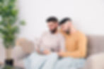 close-up-gay-couple-sitting-together-sofa-using-mobile-phone-laptop (1) 1 (1).jpg