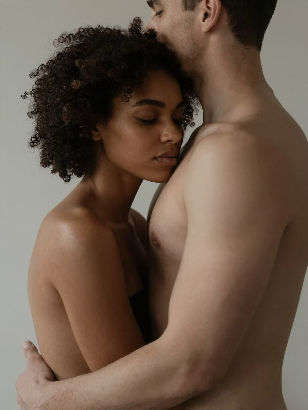 A woman resting against a partner’s bare chest in a quiet intimate moment