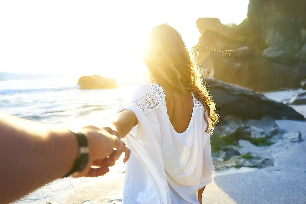 A couple walking together on a sunlit beach