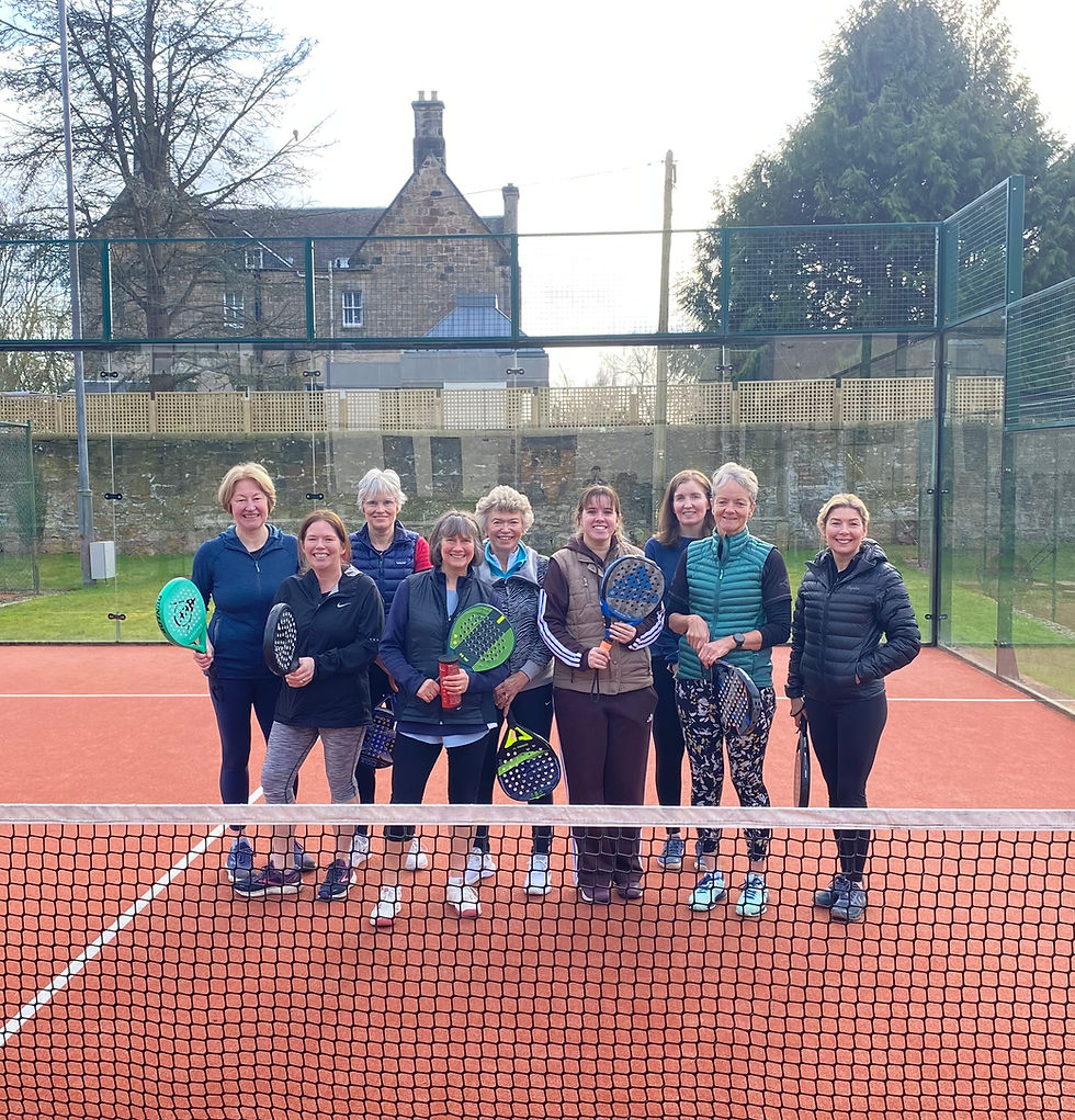 Group of women with padel rackets on a court