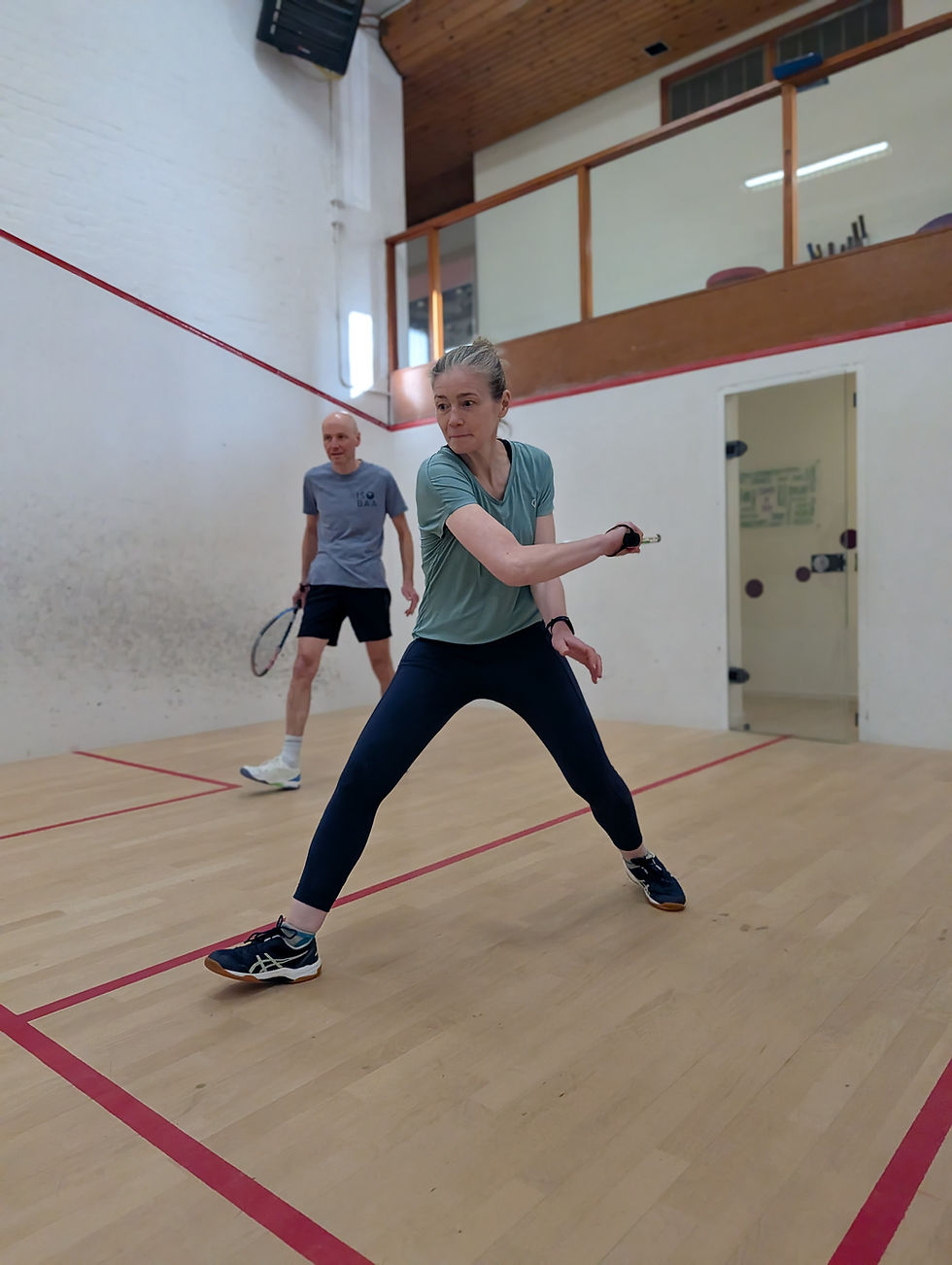 Woman playing racketball in an indoor court