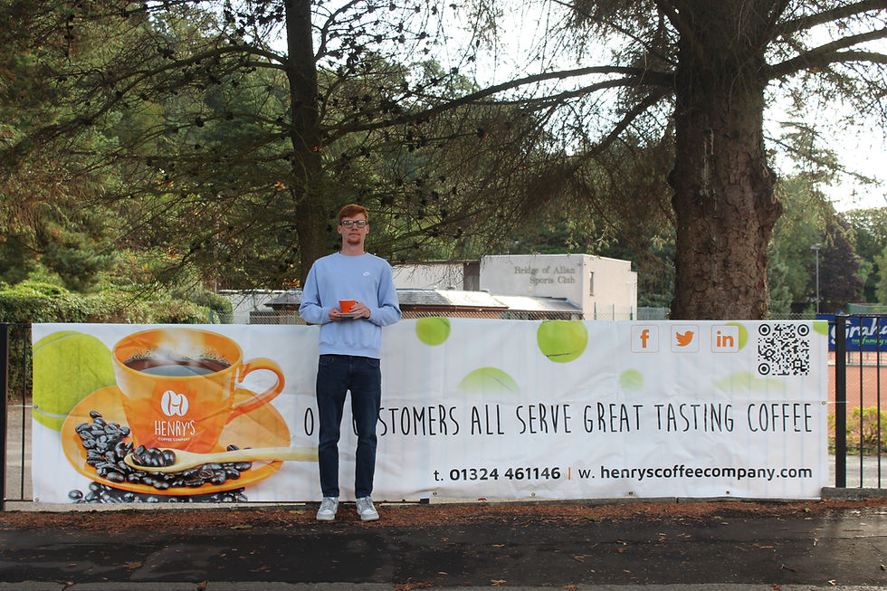 Man holding coffee by Our sponsors banner for Henry's Coffee Company