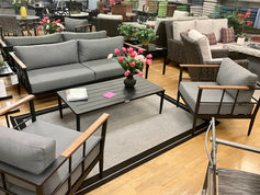Loveseat and chairs with thick, grey cushions and acacia accents.