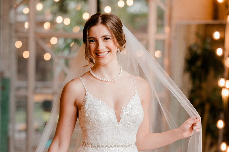 Beautiful picture of a bride smiling with makeup and hair done by Magda Designs Beauty