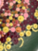 Close-up of hand-painted mandala stone highlighting intricate red, pink, gold, and yellow circular designs.