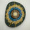Thumbnail: Hand-painted mandala stone with deep blue, turquoise, gold, and white intricate patterns, radiating from a central floral des