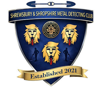 Shield-style logo for the Shrewsbury & Shropshire Metal Detecting Club featuring three lion head emblems, silhouettes of detectorists, and a banner reading “Established 2021” in blue and gold colours.