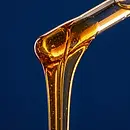 Golden hemp-derived Delta-8 THC distillate pouring from a glass rod