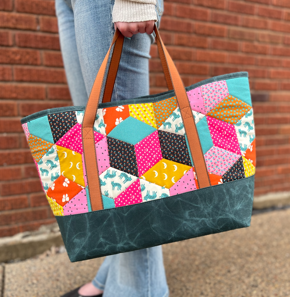 Thumbnail: Medium Everday Altoona Tote with custom-quilted cotton upper and waxed canvas base, being held by side
