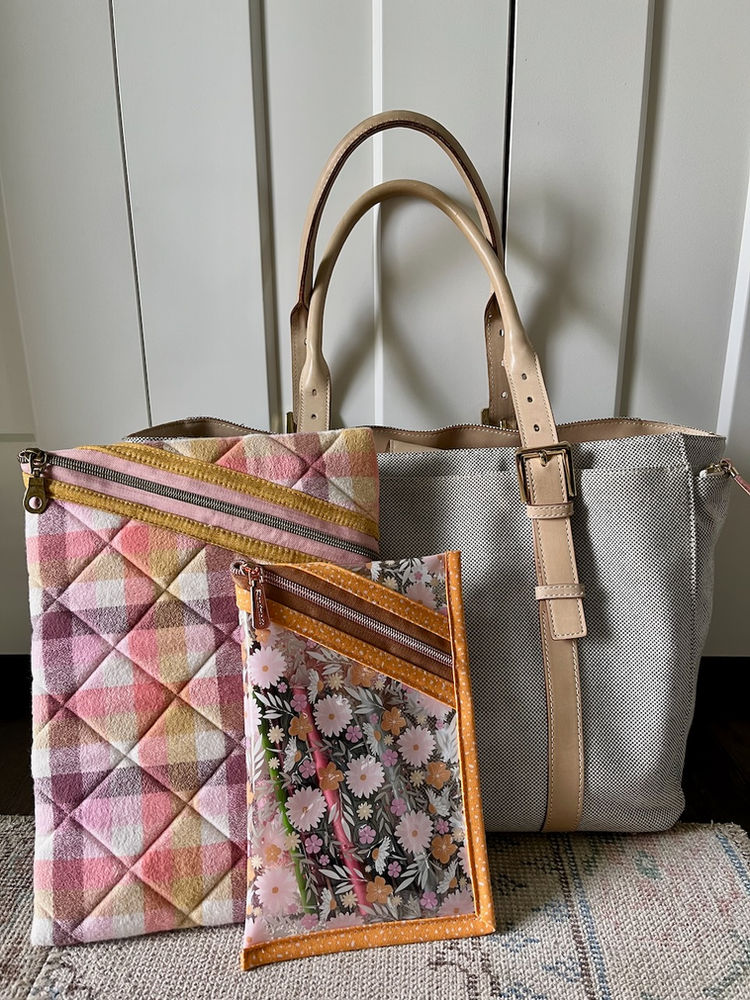 Flannel ipad case and vinyl pencil case in front of laptop bag.