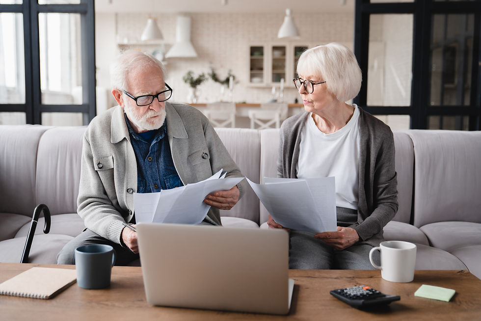 elderly couple filling our forms looking a little confused