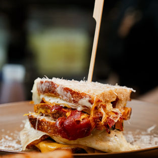 Egg sandwich on a sourdough toast with bacon, tomato jam and cheese