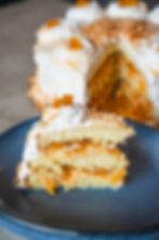 Slice of Lady Baker pineapple cake with pineapple cream, meringue, and toasted coconut