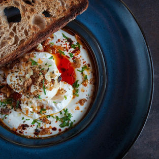 A beautiful plate of poached eggs, yogurt and sourdough toast