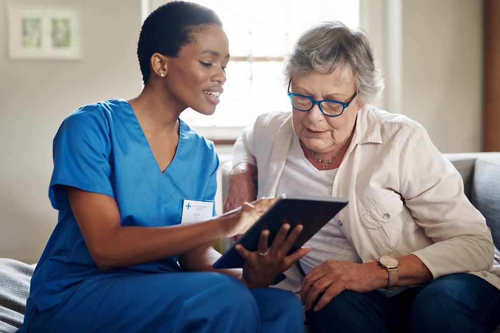 healthcare provider holding a tablet and asking medical questions to an older woman beside her