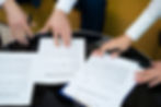 high-angle-hands-signing-documents.jpg