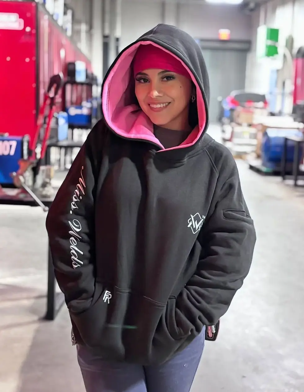FR black/pink hoodie with hard hat-ready hood and branded details. Stylish and durable