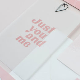 Wedding invitation suite featuring curved shape cards, a palm leaf design and soft neutral and pink colour palette. 