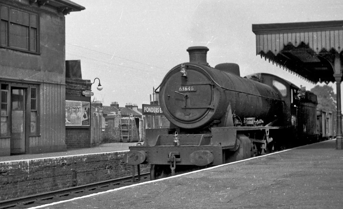 LNER O1 2-8-0 No 63646 hauls an up class H freight through Ponders End on 21 August 1959.