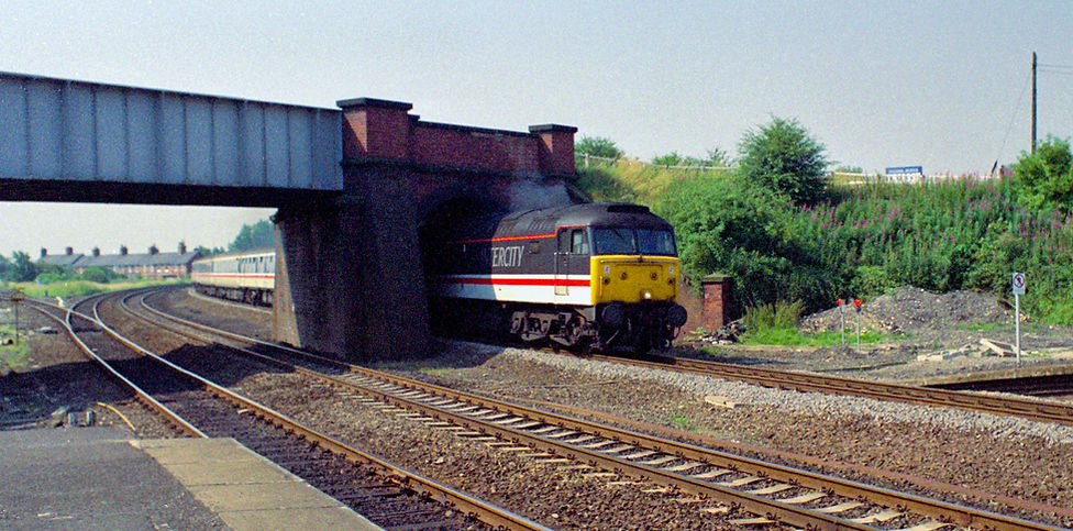 Class 47 No 47804 heads an express at Church Fenton at 10:45 on 18 July 1990.