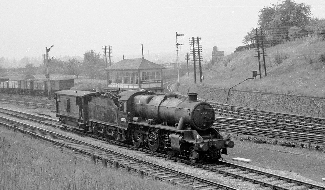 11:40 LMSR Stanier 2-6-0 No 42971 drifts past Knighton North Junction on 27 May 1963 with the brake van for a freight it will haul south later in the day.