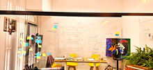 Image of a glass wall in a meeting room with post it notes