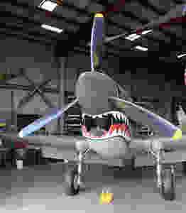 The Curtiss P-40E Warbird is a single-engine, single-seat fighter aircraft. The popular shark mouth, well suited to the contours of the P-40, was made famous by the 1941 American Volunteer Group (AVG), also known as the “Flying Tigers.” This partial aircraft was restored by the Yanks Air Museum and flew on on 16th June 2018.