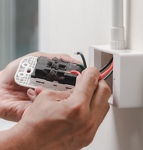 vecteezy_electrician-installs-electrical-outlet_1430212 (1).jpg