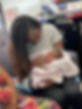 Dr. Cheryl Edinbyrd, certified midwife and counselor, holding a newborn baby in her lap at The Tree of Life Birth and Wellness Center, supporting holistic postpartum care.