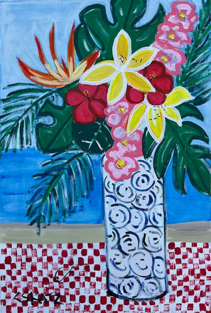 Tropical flowers in patterned vase in front of ocean