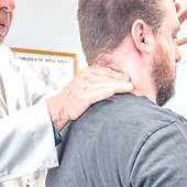 Chiropractor performing neck adjustment on patient for pain relief and improved spinal health