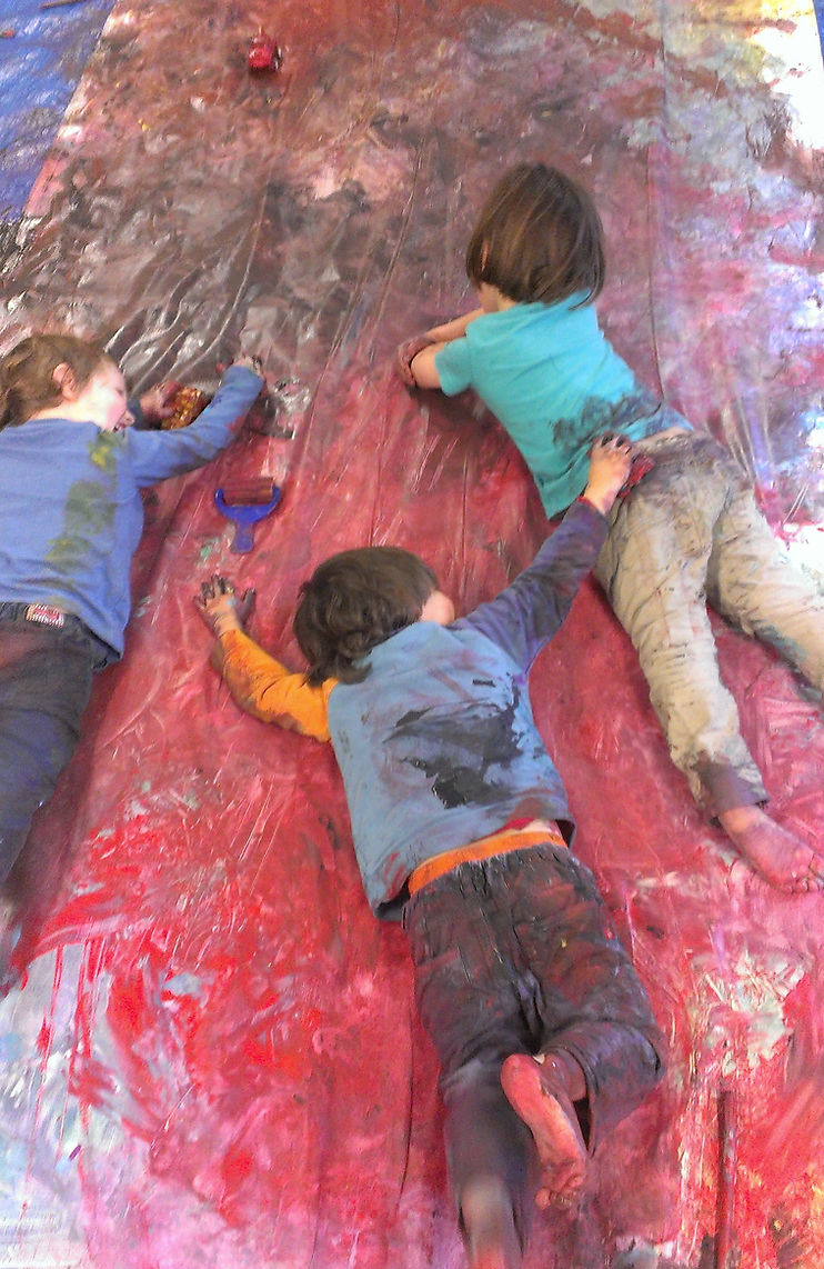 Boys at the end of a messy painting session