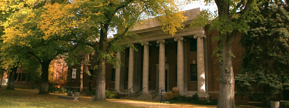 Image of building at UNR with columns and trees in front.