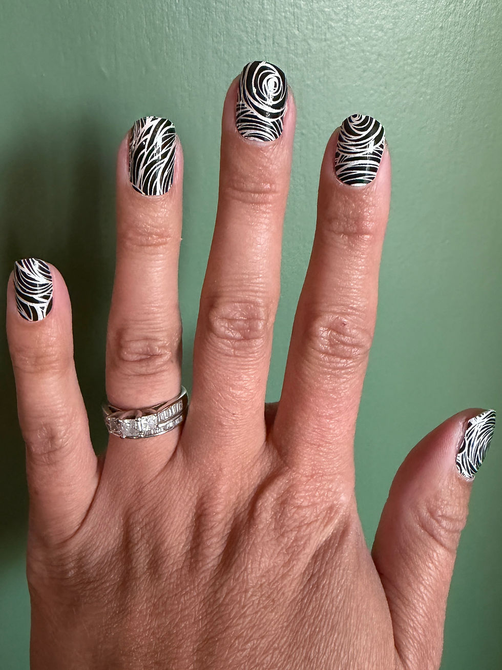Ink Swirl Nail Wrap - black and white swirls on hand model