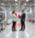 Floor of Canadian cosmetics factory. Two people shaking hands. Canadian flag in backgrou
