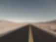 The road had just new asphalt on it. Beautiful contrast against the bare dessert landscape