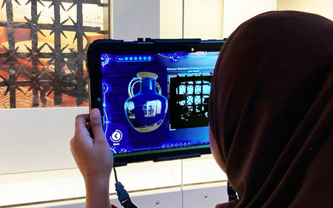 Photograph of a player using the Time Odyssey app to collect patterns through their camera lens for their digital vase.