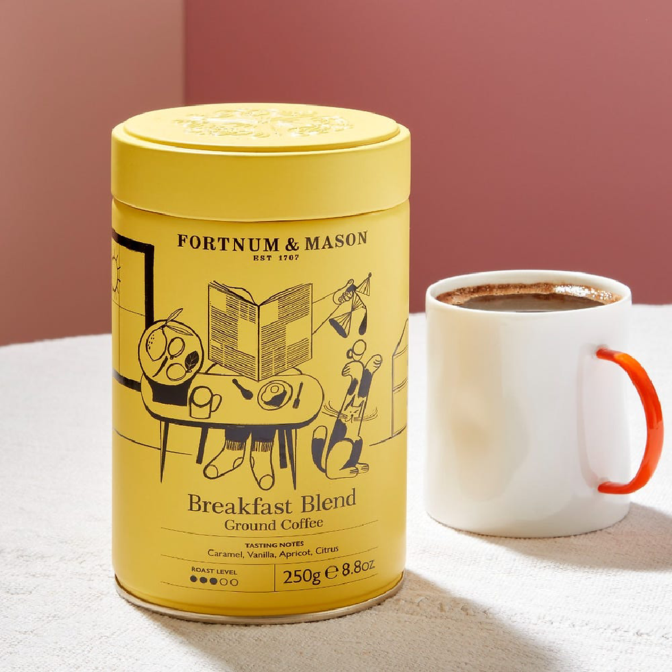 Yellow Fortnum & Mason Breakfast Blend Ground Coffee 250g beside a cup of coffee.