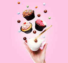 Flying cupcakes, cup of tea, candy and a hand