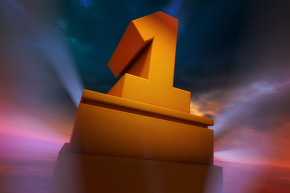 Number One on a plinth with searchlights