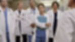 Cristina Yang (Sandra Oh) stands with other doctors in their lab coats. Could there be a Sandra Oh return to Grey's?