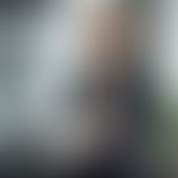 Blonde FDA drug regulator resigns amidst toxic environment claims, holding resignation papers in an office.