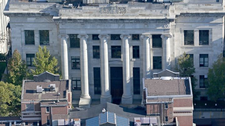 Aerial view of the iconic Harvard Medical School facade featuring massive white marble columns and classical architecture on the medical campus.