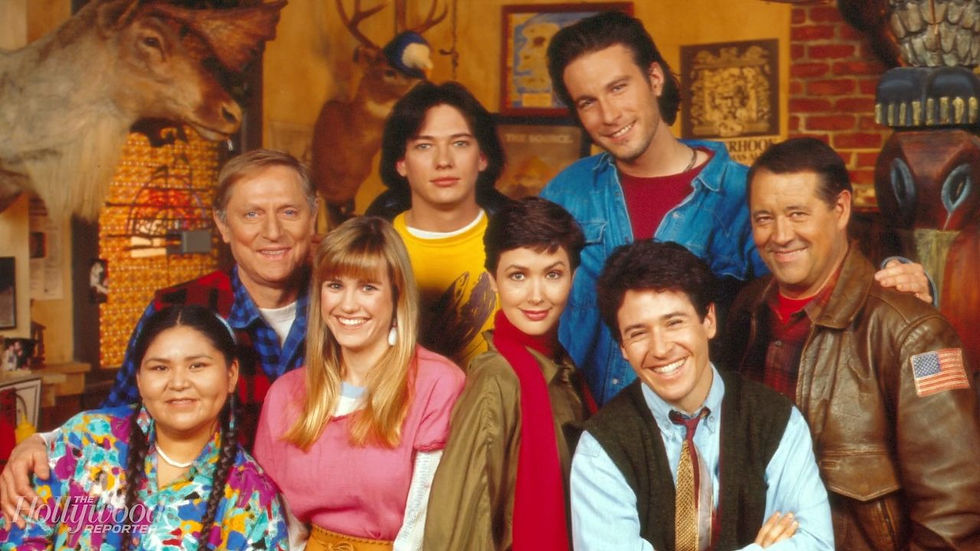 The beloved cast of Northern Exposure, including Joel, Maggie, and Chris, together in a warm, quirky interior, ready for its streaming debut.
