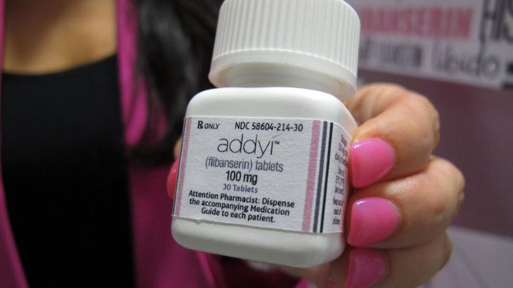 Prescription bottle of Addyi (flibanserin) 100 mg tablets held by a patient, highlighting pharmaceutical treatment for female sexual dysfunction.
