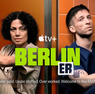 Berlin ER Season 2 key art with two main characters, a woman in scrubs and a man in blue scrubs, against an orange wall.