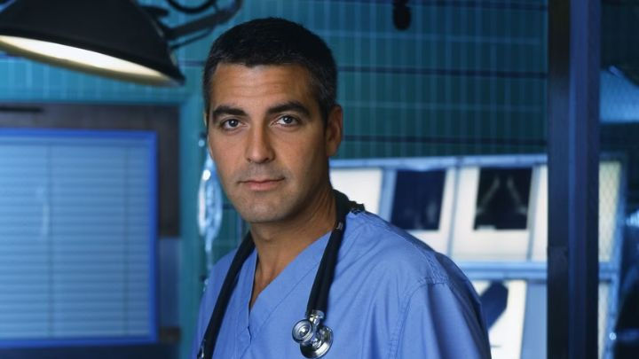 George Clooney as Dr. Doug Ross, with a stethoscope around his neck, sparking rumors of a possible The Pitt reunion.