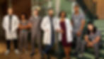 The full cast of Brilliant Minds Season 2, posing together with a mix of medical professionals in their uniforms and lab coats.