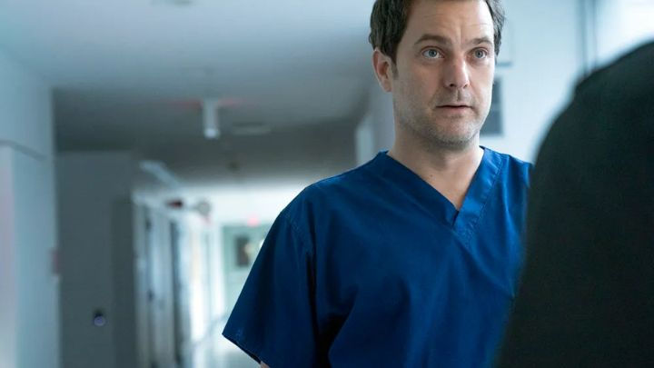 Joshua Jackson wears blue scrubs and looks concerned as Dr. Christopher Duntsch in the true crime medical drama Dr. Death.
