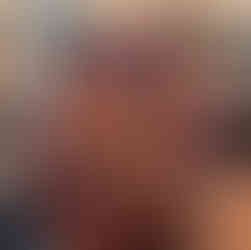 Nino modestly hides behind her creation